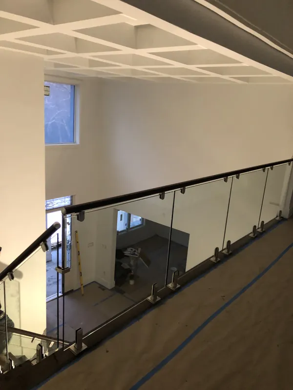 Glass railing overlooking an interior staircase